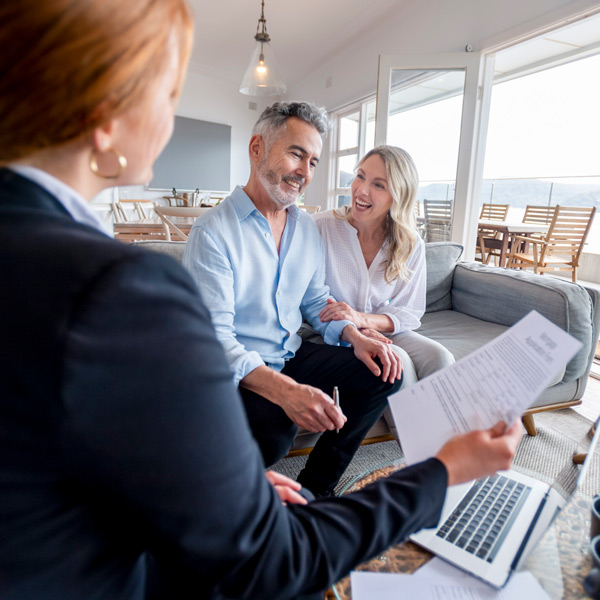 Happy mature couple meeting investments and financial advisor at home